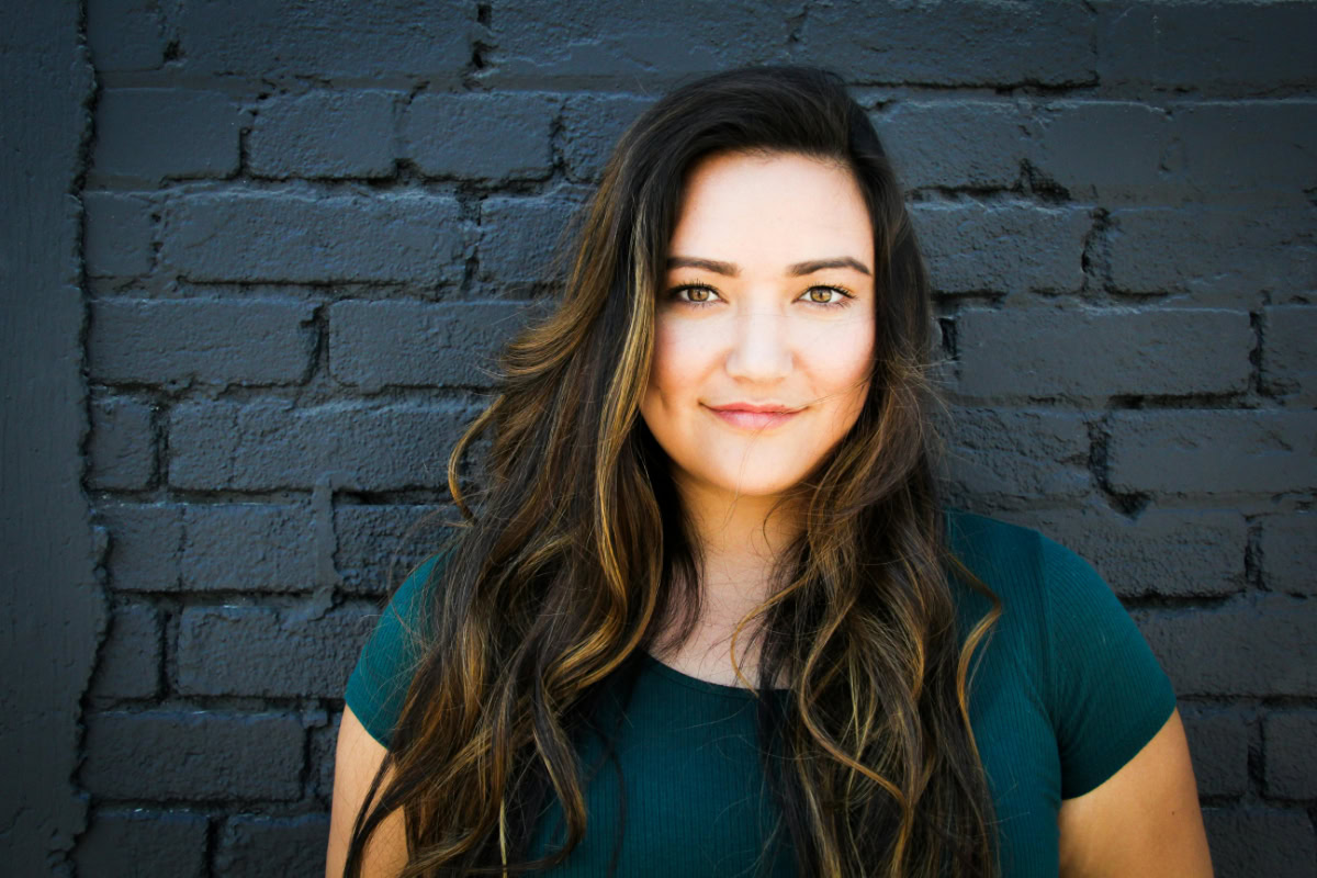 Woman with a blonde balayage on her brunette hair.