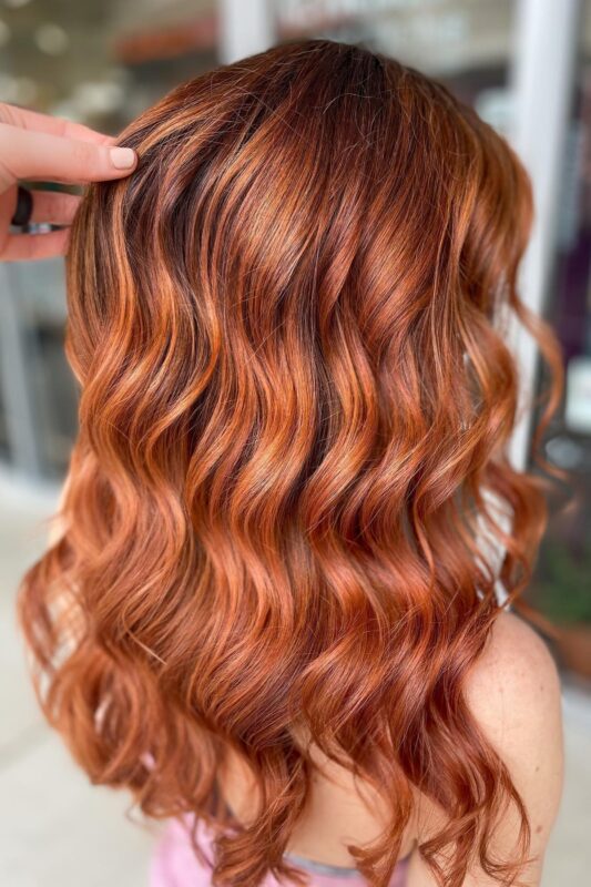 Woman with a chestnut copper brown hair color.