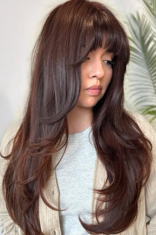 A woman with a deep chocolate brown hair color.