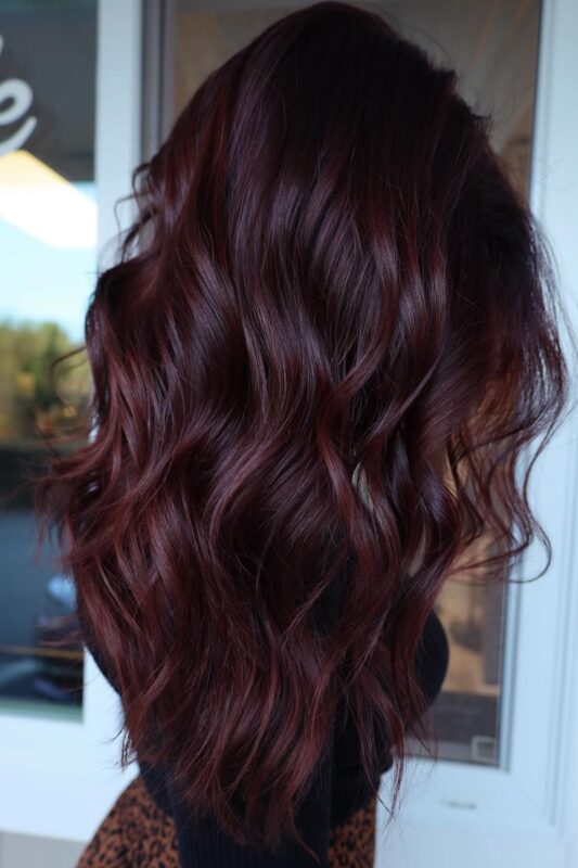 A woman with a chocolate cherry hair color.