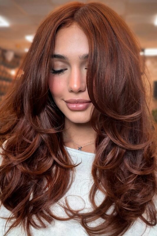 A woman with a cinnamon brown hair color.