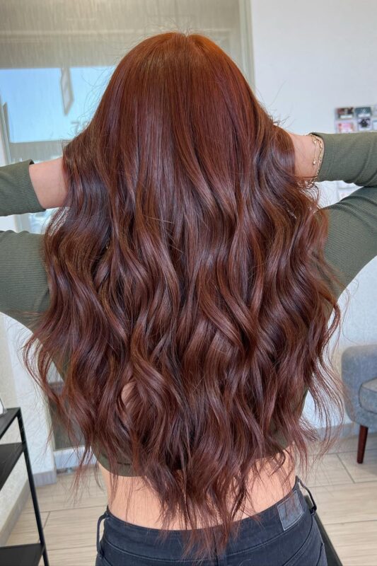 A woman with a copper brown hair color.