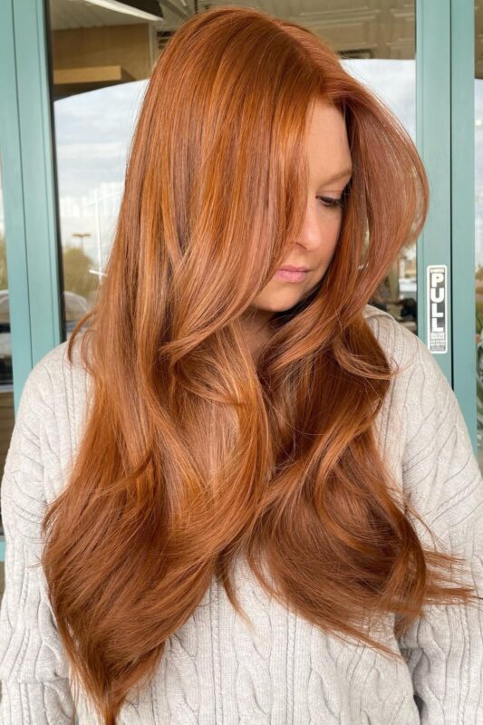 Woman with a cowboy copper hair color.