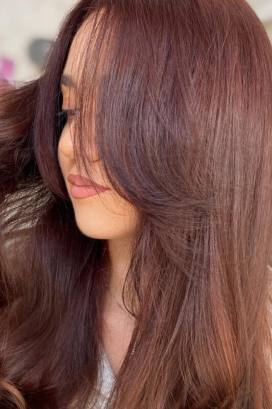 Woman with dark copper brown hair.