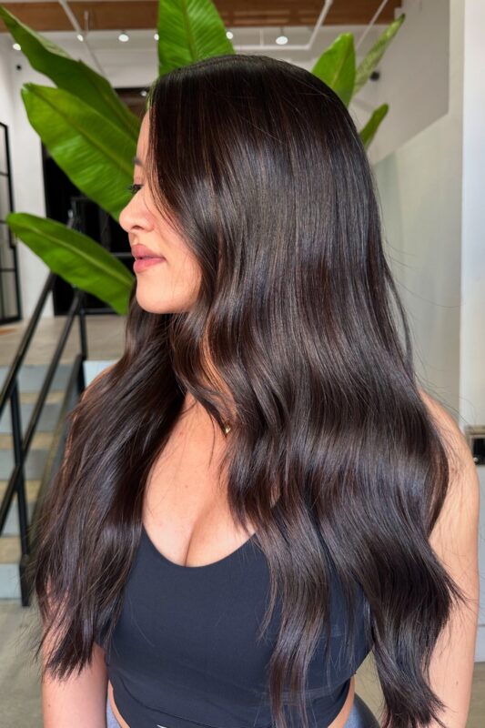 A woman with an espresso brown hair color.