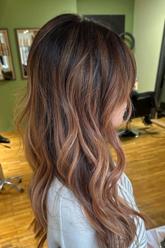 A woman with a ginger brown hair color.