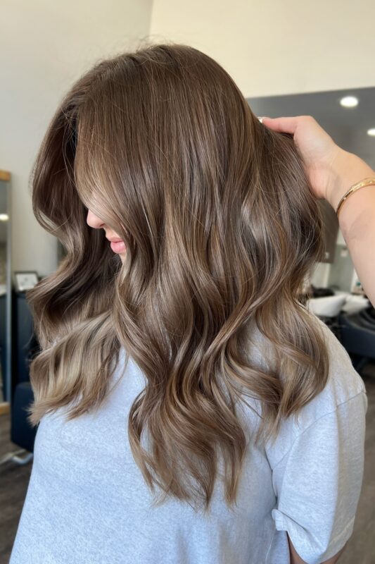 A woman with a light chestnut brown hair color.