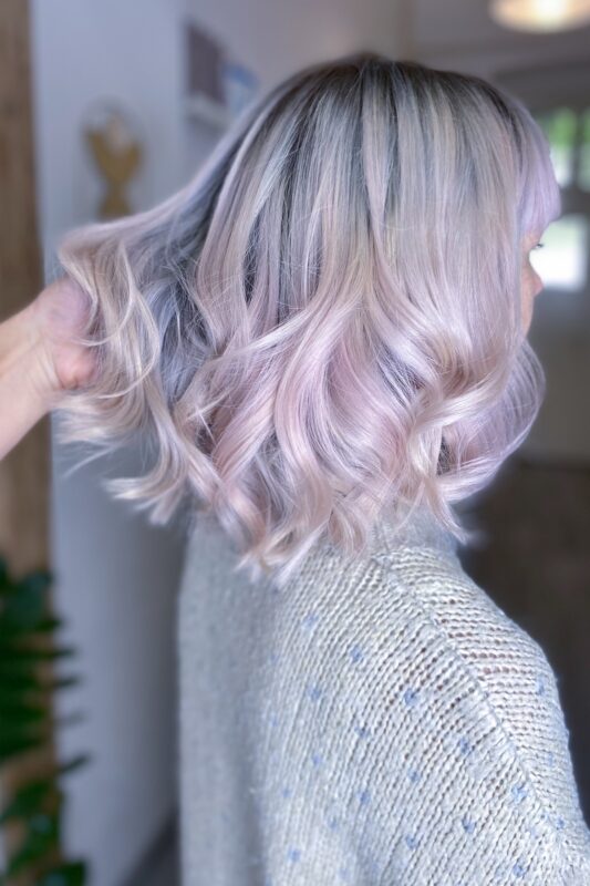 Woman with very light pink hair.