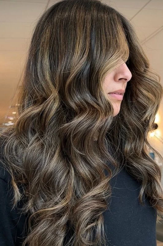 Woman with medium brown hair and golden blonde highlights.