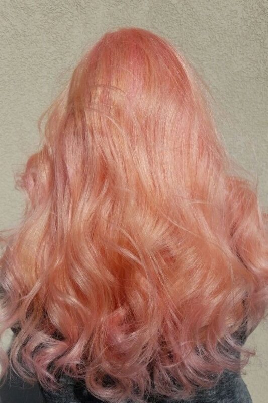 Woman with a pastel peach hair color.