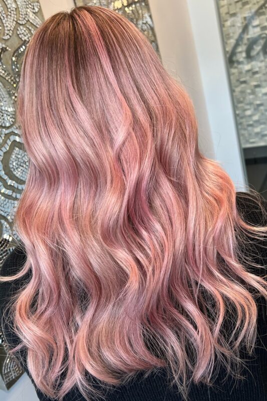 Woman with peach and rose gold hair.