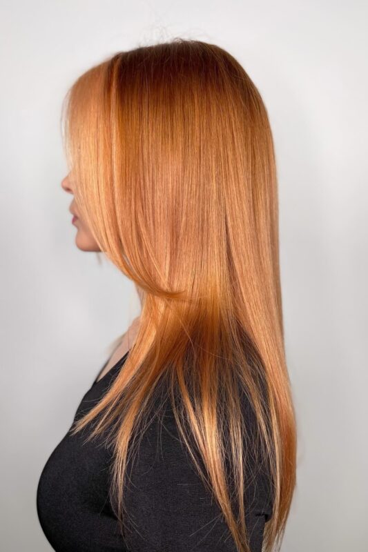 Mujer con cabello color melocotón cobrizo.