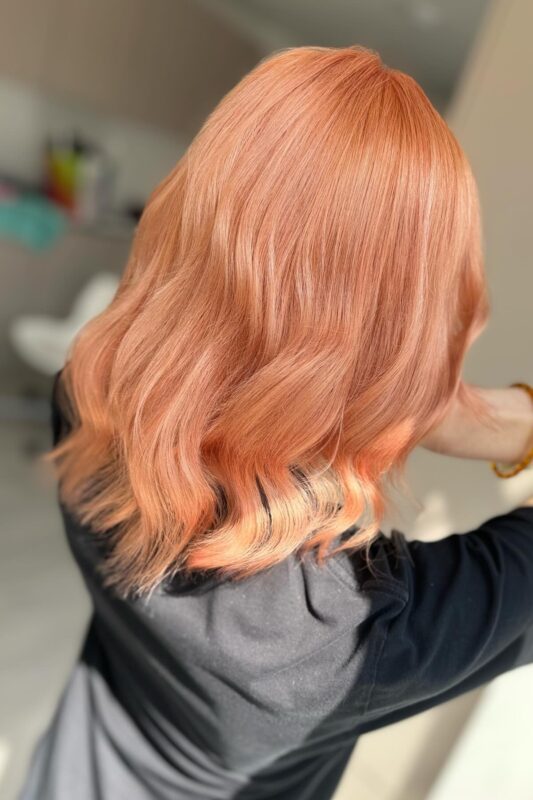 Woman with a peach hair color.