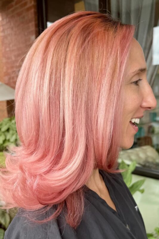 Woman with a peach rose gold hair color.