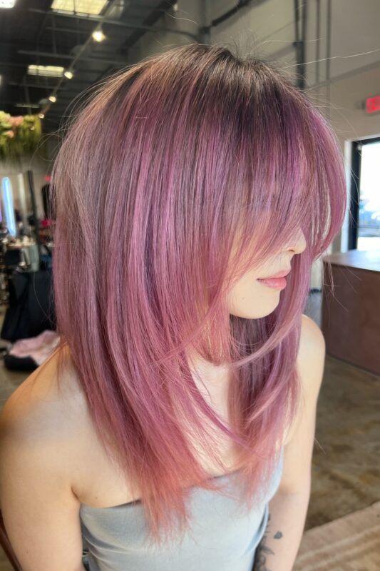 Woman with pinkish purple hair.