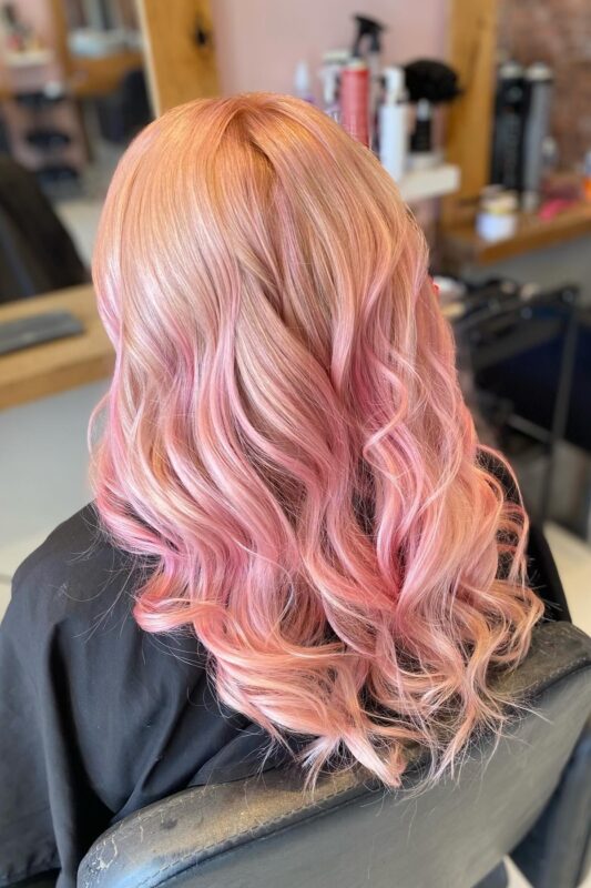 Woman with rose gold pink blonde hair.