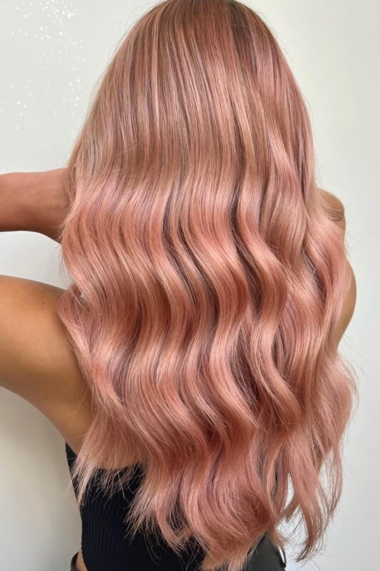 Woman with a rose gold pink hair color.