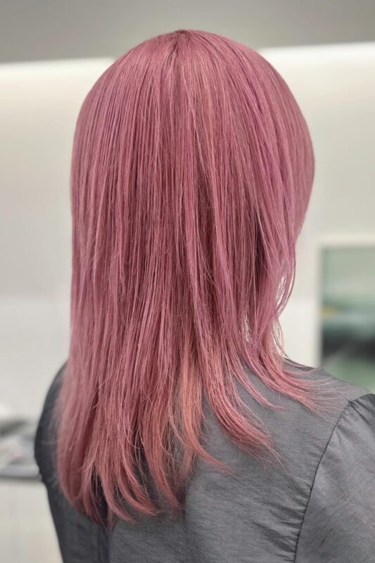 Woman with rose pink hair.