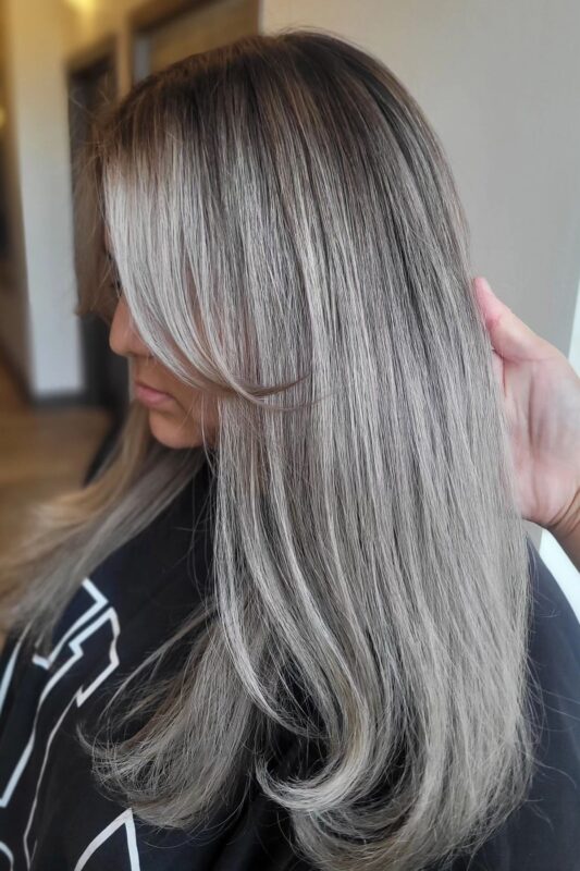 Woman with full silver highlights on dark hair.