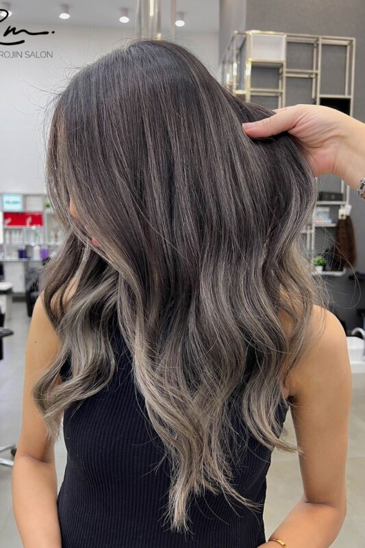 Woman with an ash brown balayage.