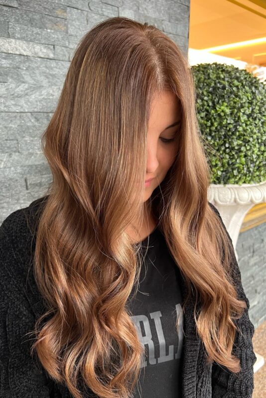 Woman with brown and rose gold hair.