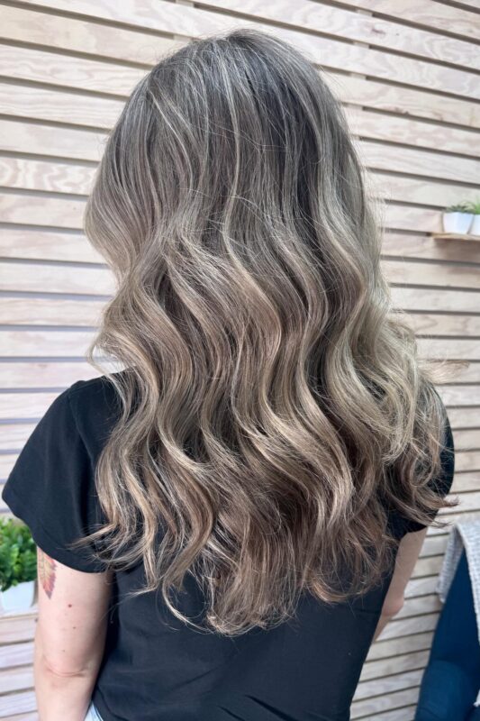 Brunette grey blending with icy blonde highlights for a fresh, dimensional effect.