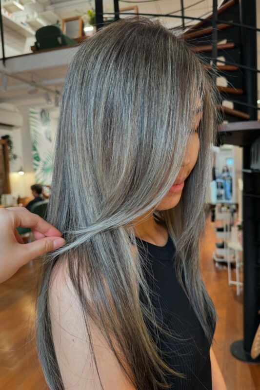 Brunette hair with grey highlights for blending greys naturally and stylishly.