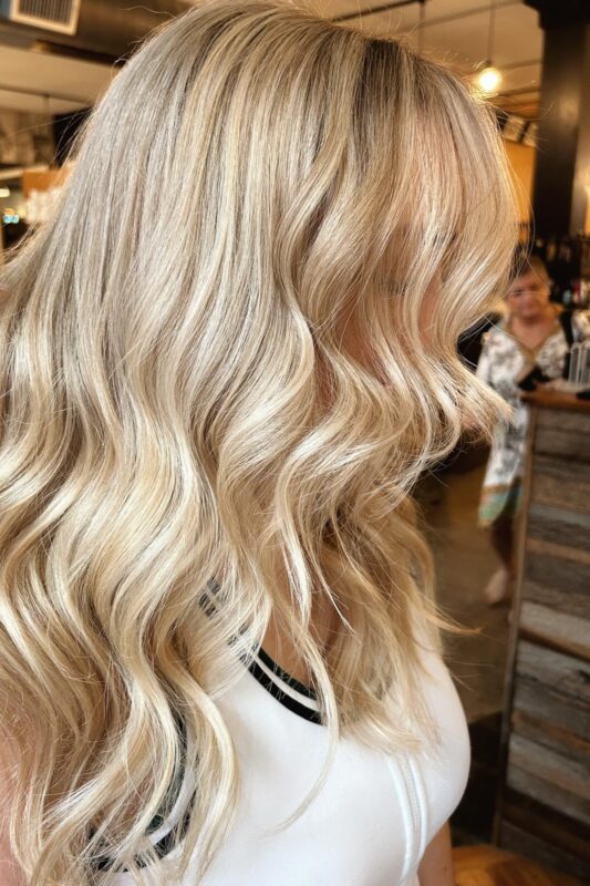 Woman with a buttercream blonde hair color.