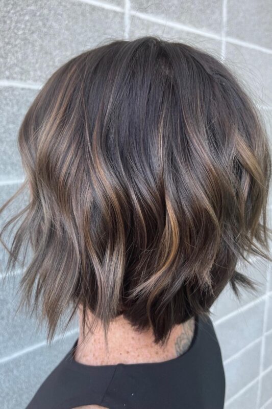 Woman with cool caramel highlights.