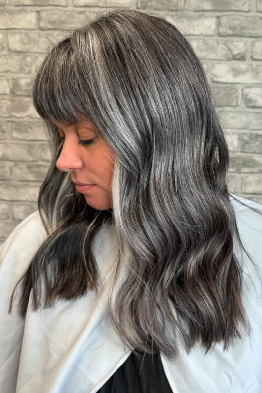 Dark hair grey blending with silver highlights for a chic, modern finish.