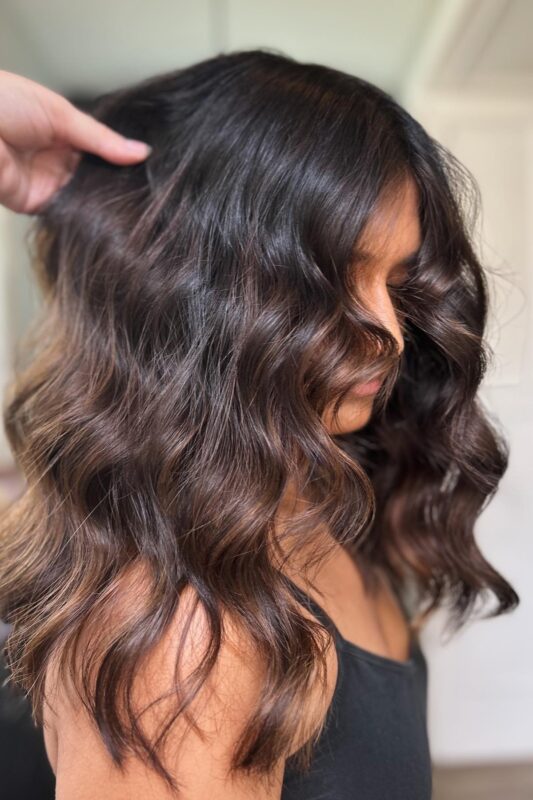 Woman with espresso highlights on her brown hair.