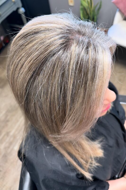 Soft golden blonde highlights to hide gray hair with a touch of warmth.