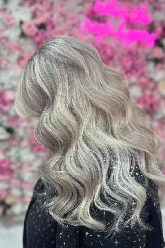 Blonde hair with natural highlights to blend gray effortlessly.