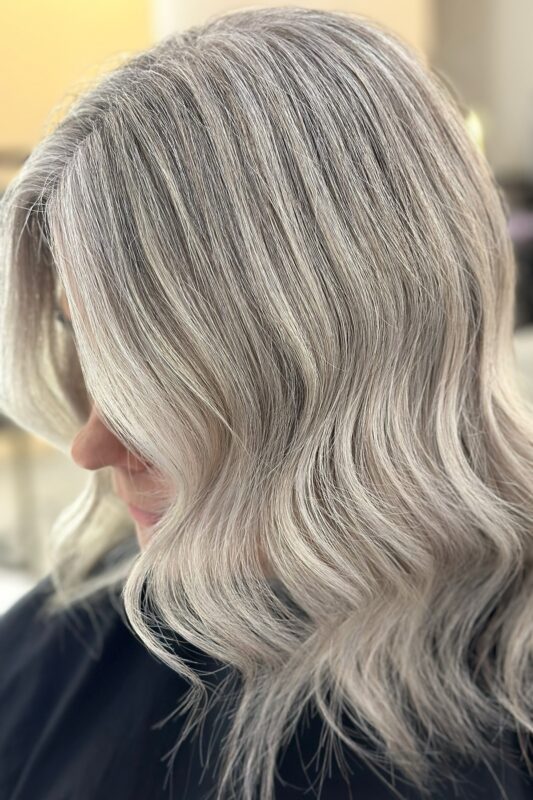 Gray blending for blonde hair with cool blonde highlights for a seamless look.