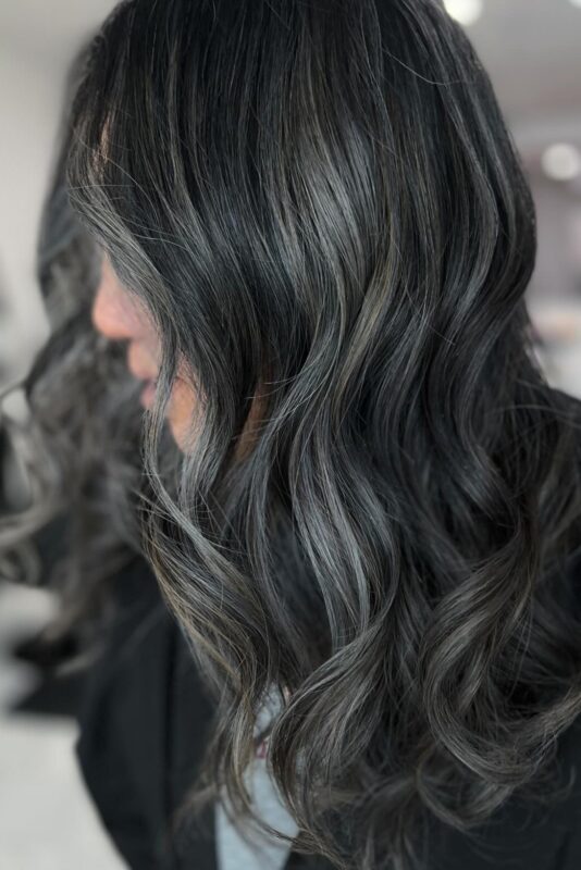 Grey blending black hair with ashy highlights for a smooth, modern result.