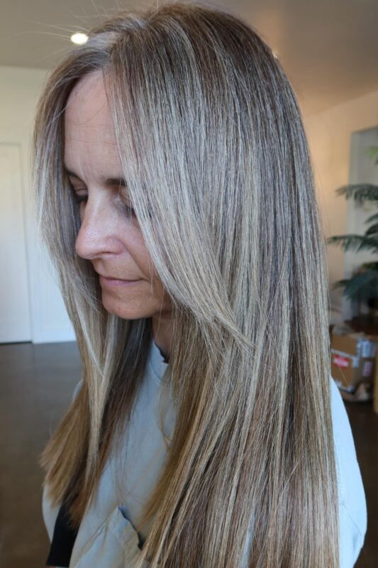 Dark brown hair enhanced by grey blending silvery grey highlights.