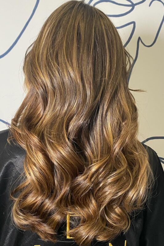 Woman with a honey brown balayage.