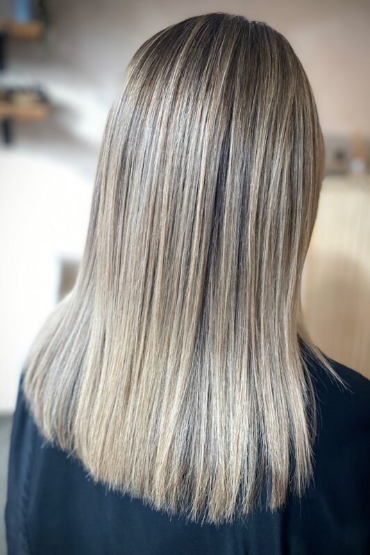 Icy blonde highlights blending gray effortlessly for brunettes.