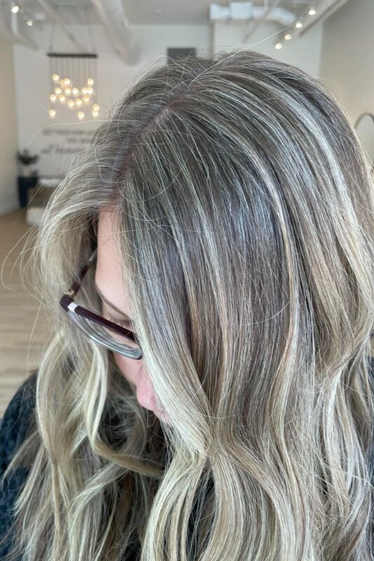 Icy blonde highlights to hide grey hair for a bright, fresh appearance.