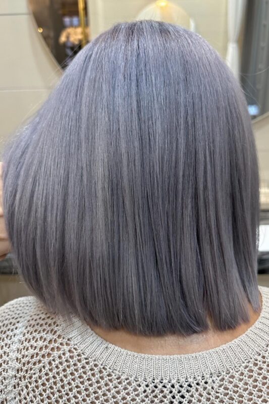 Woman with a lavender grey hair color.