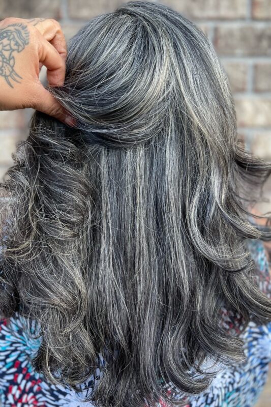 Dark hair grey blending with silver and grey highlights for a sophisticated touch.