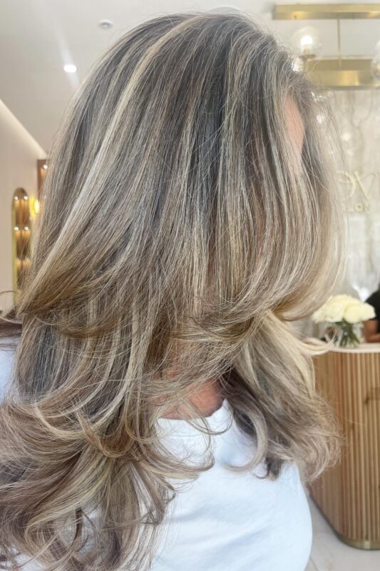 Warm blonde blended gray highlights for a subtle, radiant effect.