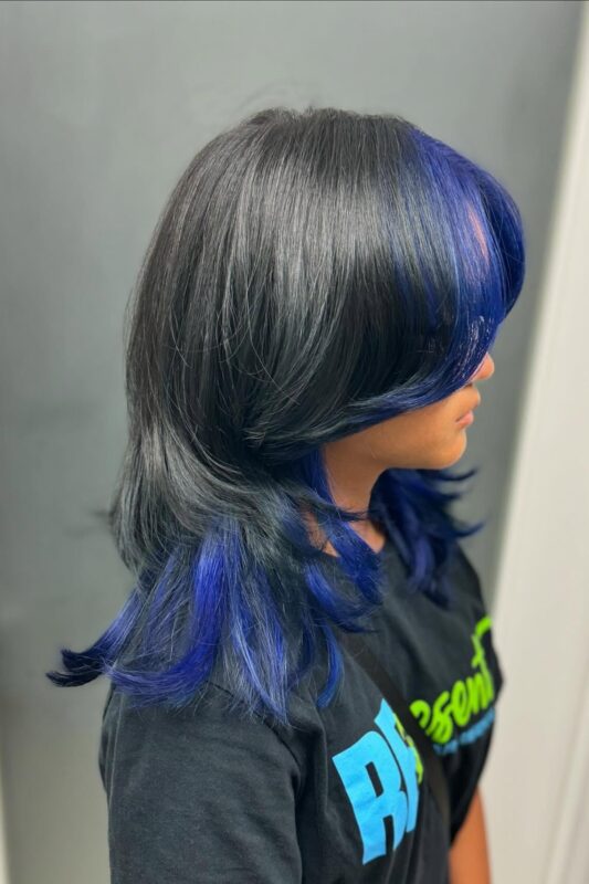 Woman with blue peekaboo highlights.