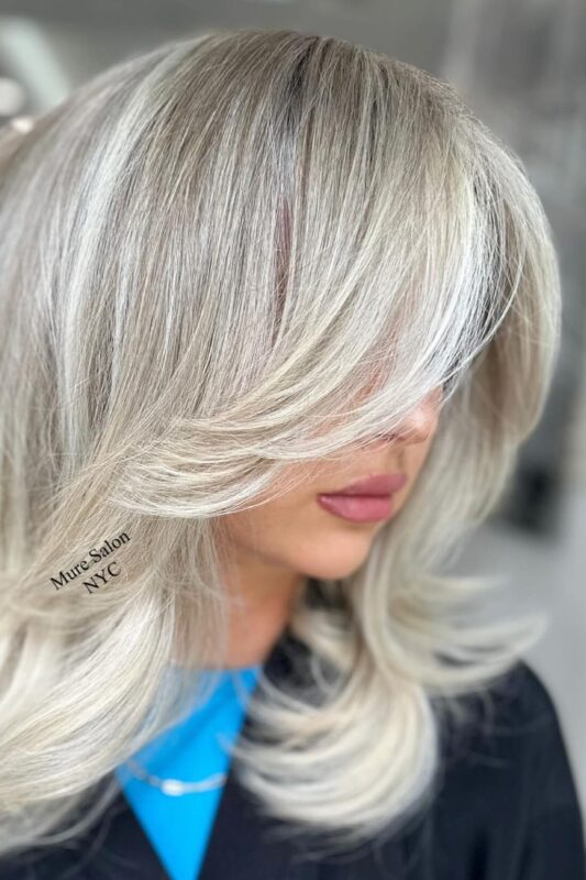 Woman with champagne blonde balayage.