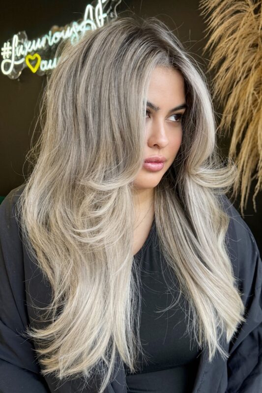 Woman with a face-framing long layers haircut.