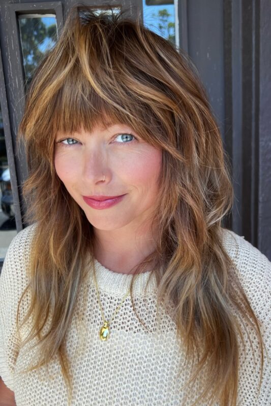 Woman with a face-framing haircut for long hair.