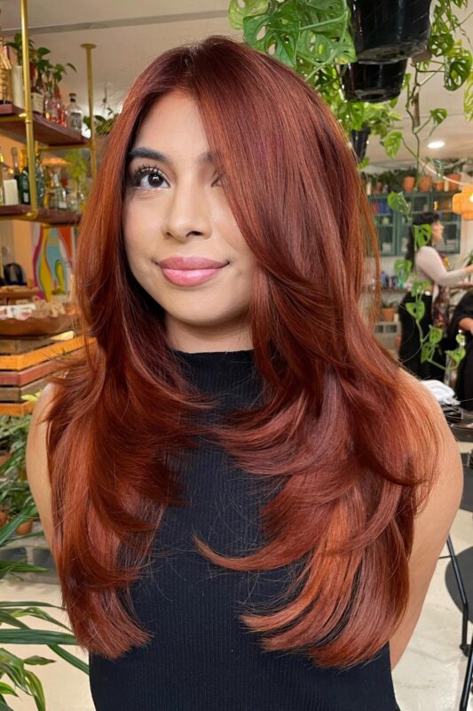 Woman with a face-framing butterfly layers haircut.