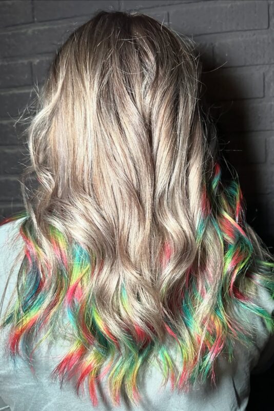 Woman with a holographic prism hair color.