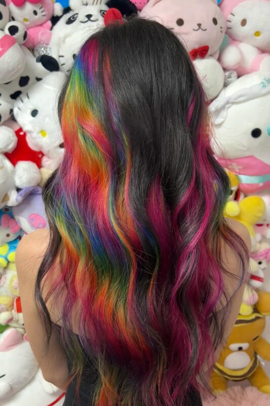 Woman with a rainbow peekaboo hair color.