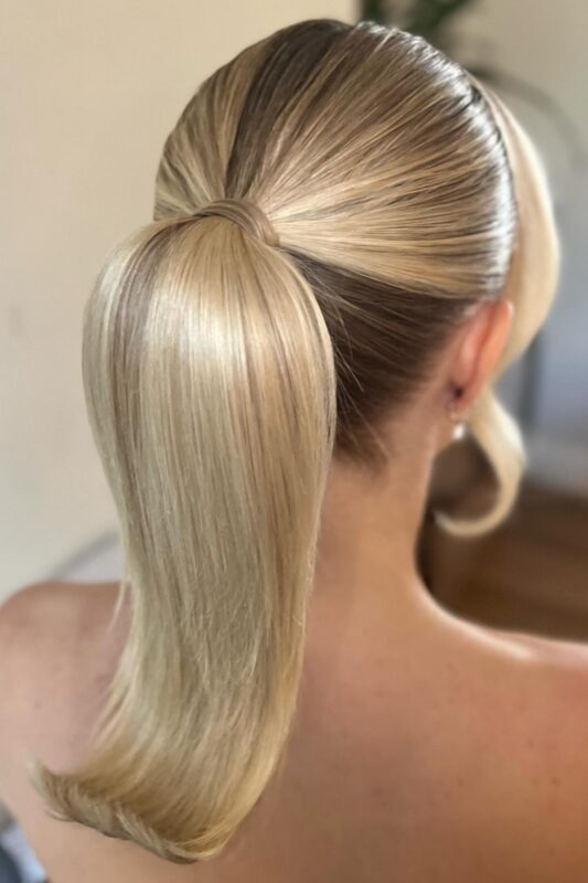 Woman with a sleek retro-style high ponytail.